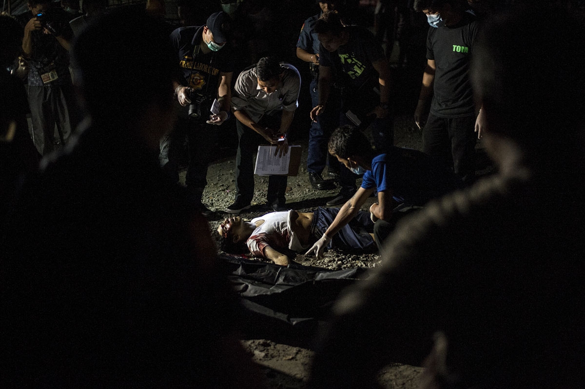 The body of an alleged drug pusher lies in a street of Manila on July 27, 2016