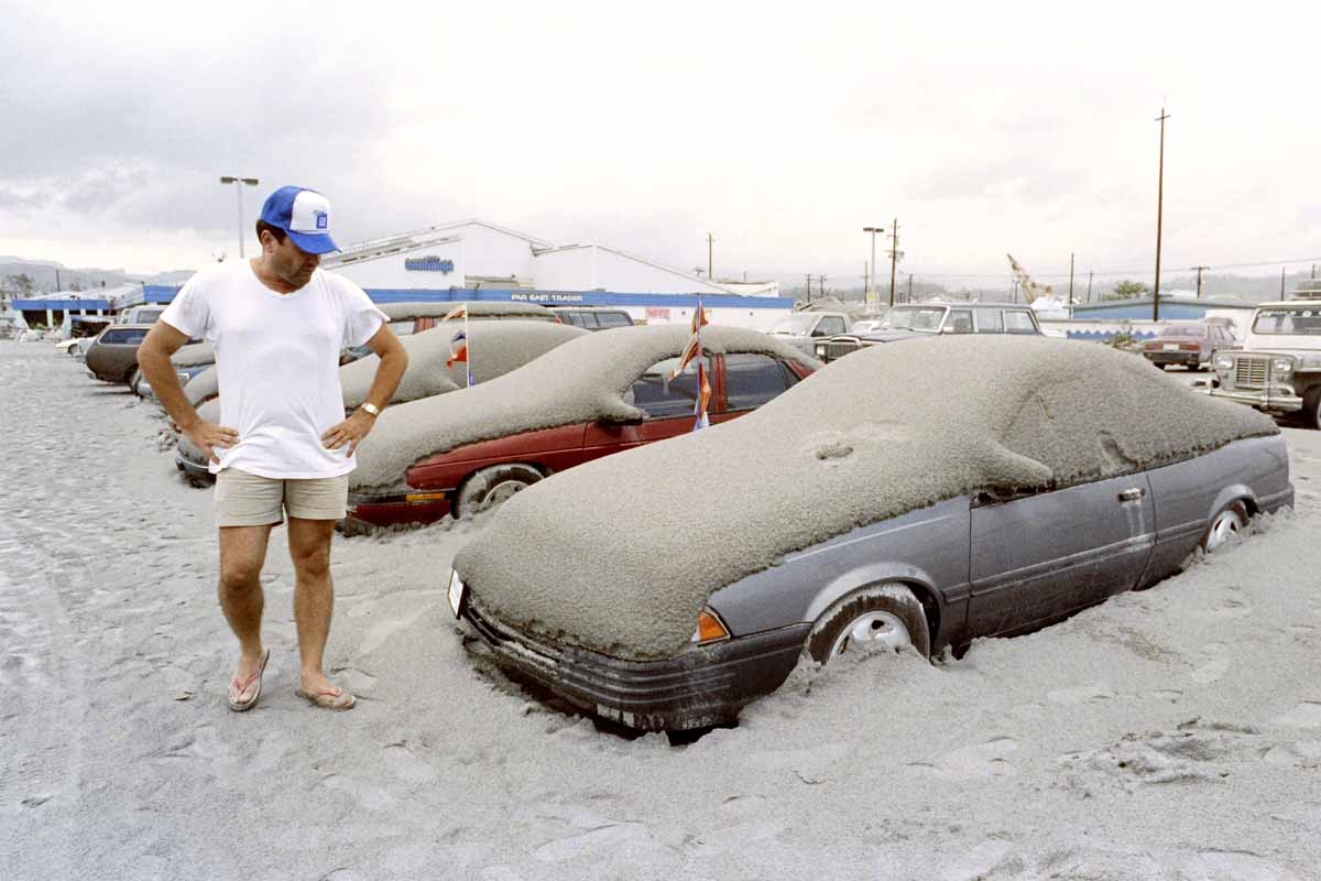 A US Navy personnel looks at his volcanic ash covered car at the Subic Naval Base parking lot, on June 19, 1991 A US Navy personnel looks at his volcanic ash covered car at the Subic Naval Base parking lot, on June 19, 1991
