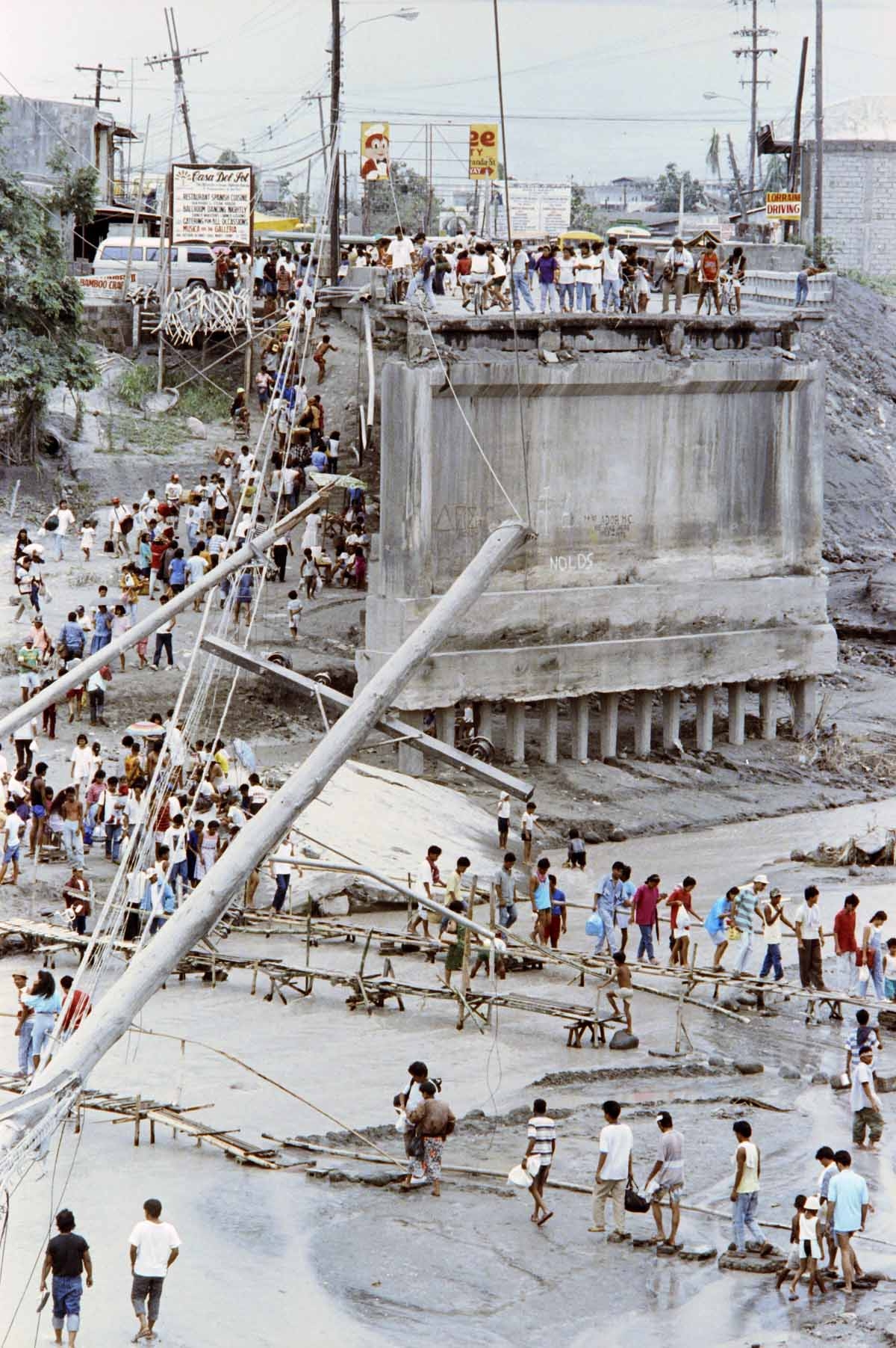 Angeles City residents cross the river on improvised wooden bridges, on June 20, 1991 after Abacan was destroyed by flash flood and mudflows from combined effects of typhon, eruption of Mount Pinatubo volcano and earthquakes Angeles City residents cross the river on improvised wooden bridges, on June 20, 1991 after Abacan was destroyed by flash flood and mudflows from combined effects of typhon, eruption of Mount Pinatubo volcano and earthquakes