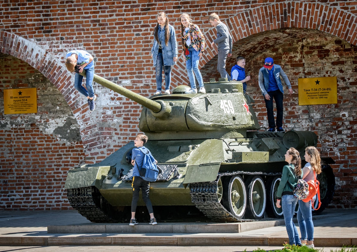 Children play atop a Soviet T-34 tank at a local military museum in Nizhny Novgorod on May 21, 2018.