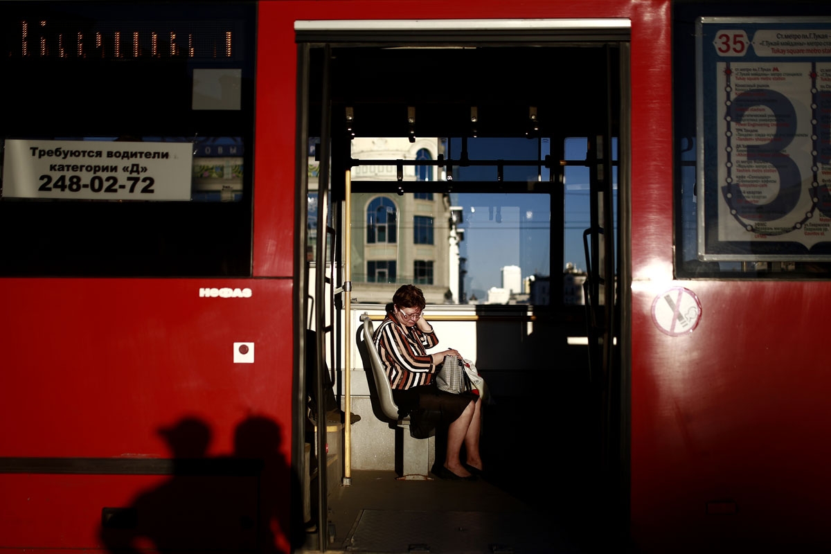 A woman sits in a bus in Kazan on June 17, 2018 during the Russia 2018 World Cup football tournament. / AFP PHOTO / Benjamin CREMEL