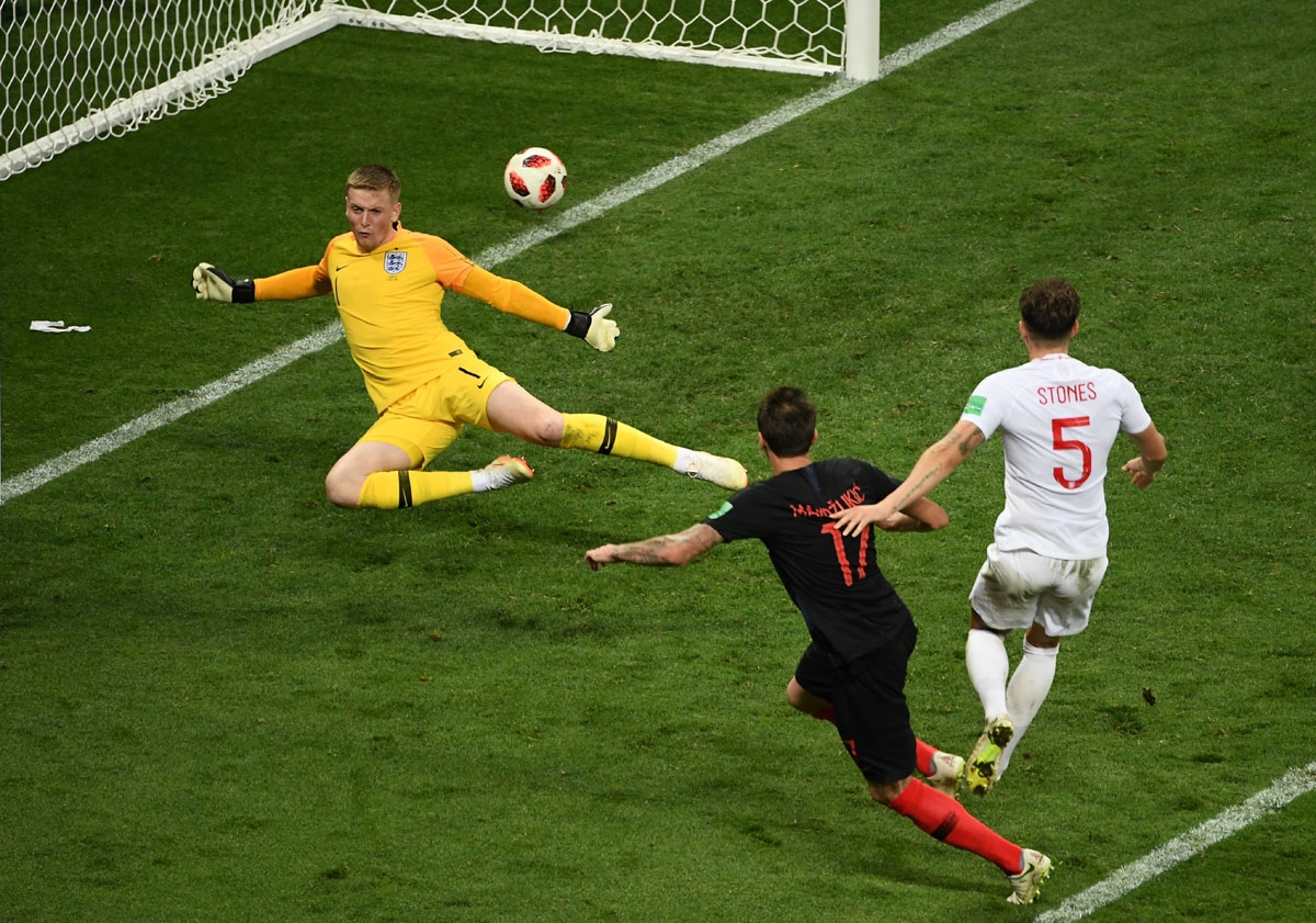Croatia's forward Mario Mandzukic (C) shoots and scores his team's second goal during the Russia 2018 World Cup semi-final football match between Croatia and England at the Luzhniki Stadium in Moscow on July 11, 2018