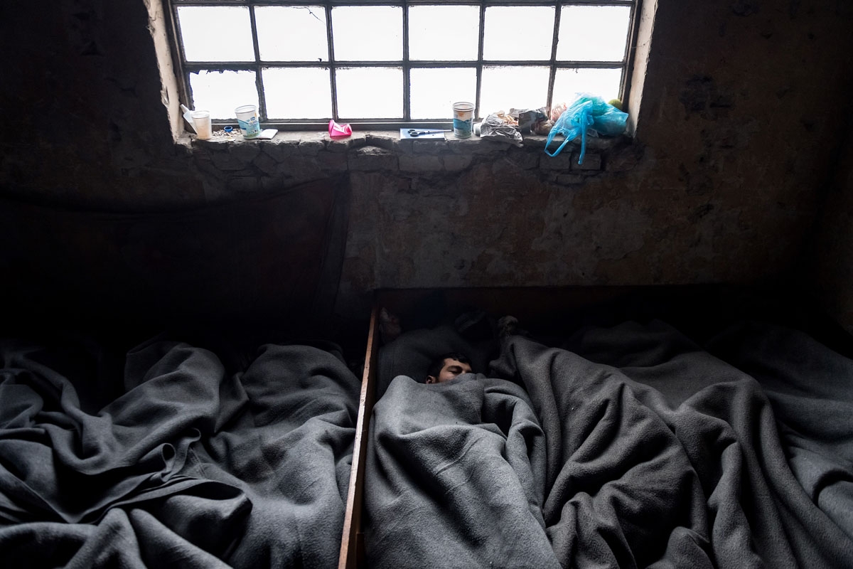 Migrants sleep inside a derelict warehouses near Belgrade's main railway station on January 17, 2017, with temperatures bellow zero Celsius. 