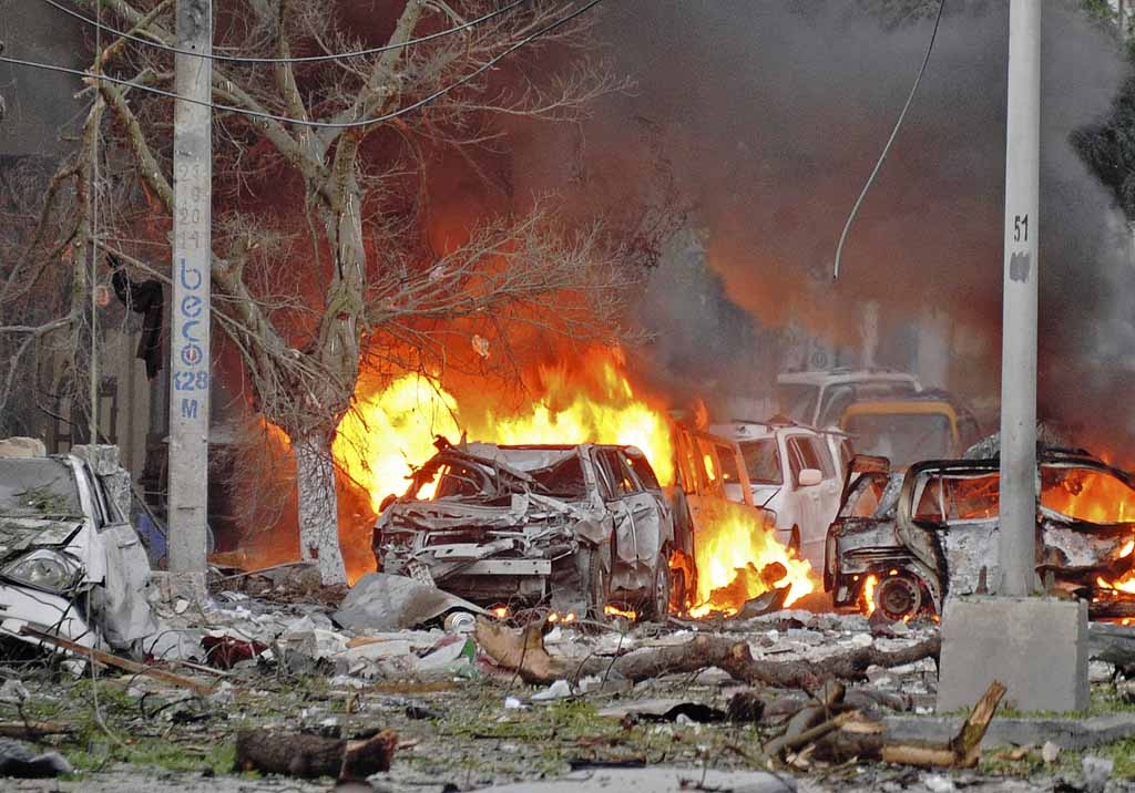 Wrecked cars burn at the scene of a terror attack at the Ambassador Hotel, after a car bomb exploded on June 1, 2016 at a top Mogadishu hotel that houses several MPs, killing several people, and followed by a gun battle. Wrecked cars burn at the scene of a terror attack at the Ambassador Hotel, after a car bomb exploded on June 1, 2016 at a top Mogadishu hotel that houses several MPs, killing several people, and followed by a gun battle.