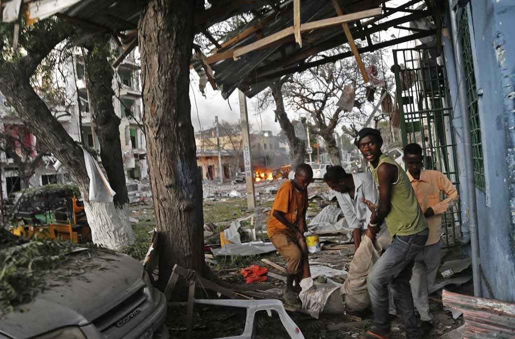 A victim is carried away from the scene of a terror attack at the Ambassador Hotel, after a car bomb exploded on June 1, 2016 at a top Mogadishu hotel that houses several MPs, killing several people, and followed by a gun battle. A victim is carried away from the scene of a terror attack at the Ambassador Hotel, after a car bomb exploded on June 1, 2016 at a top Mogadishu hotel that houses several MPs, killing several people, and followed by a gun battle.
