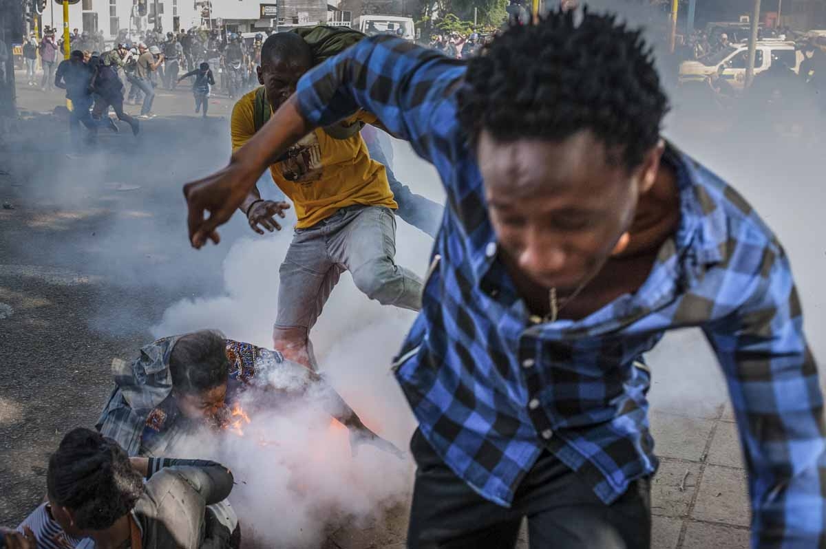 Students from the University of the Witwatersrand are injured by a police grenade during a protest against university fee increases on September 21, 2016 in Johannesburg, South Africa. Students from the University of the Witwatersrand are injured by a police grenade during a protest against university fee increases on September 21, 2016 in Johannesburg, South Africa.