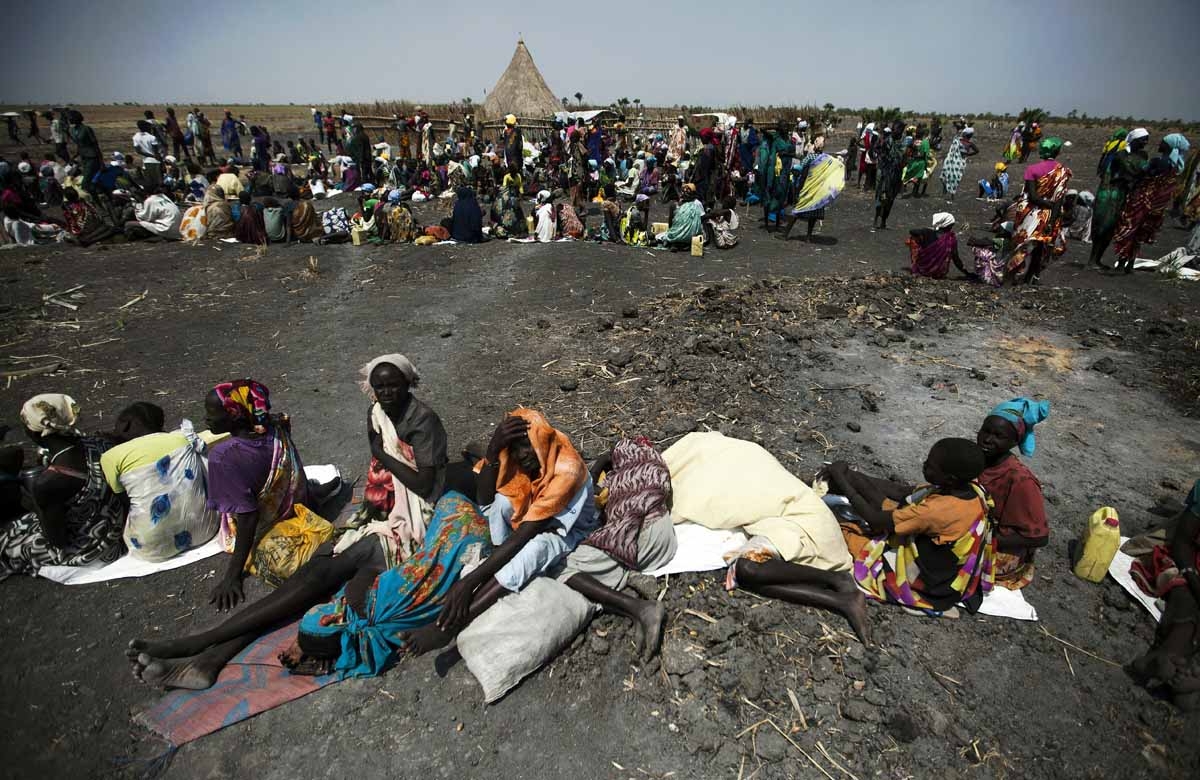 A large number of people wait for food air-drops by ICRC (International Committee of the Red Cross), outside Thonyor, in South Sudan, on February 3, 2016.