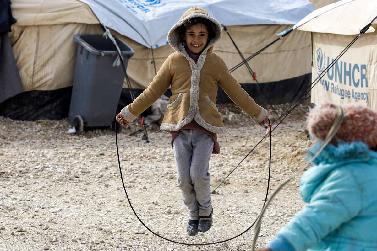 A displaced Syrian child, fleeing from Deir Ezzor city besieged by Islamic State (IS) group fighters, skips on a rope in a refugee camp in al-Hol, located some 14 kilometers from the Iraqi border in Syria’s northeastern Hassakeh province, on February 1, 2