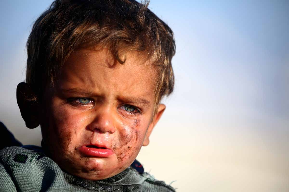 A Syrian boy cries as he is being held at a temporary refugee camp in the village of Ain Issa, housing people who fled Islamic State group's Syrian stronghold Raqa, some 50 kilometres (30 miles) north of the group's de facto capital on March 25, 2017.