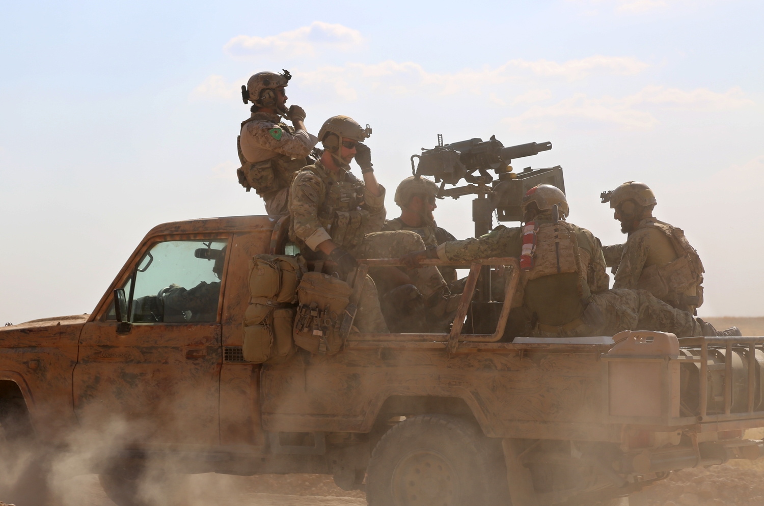 Armed men in uniform identified by Syrian Democratic forces as US special operations forces ride in the back of a pickup truck in the village of Fatisah in the northern Syrian province of Raqa on May 25, 2016. Armed men in uniform identified by Syrian Democratic forces as US special operations forces ride in the back of a pickup truck in the village of Fatisah in the northern Syrian province of Raqa on May 25, 2016.