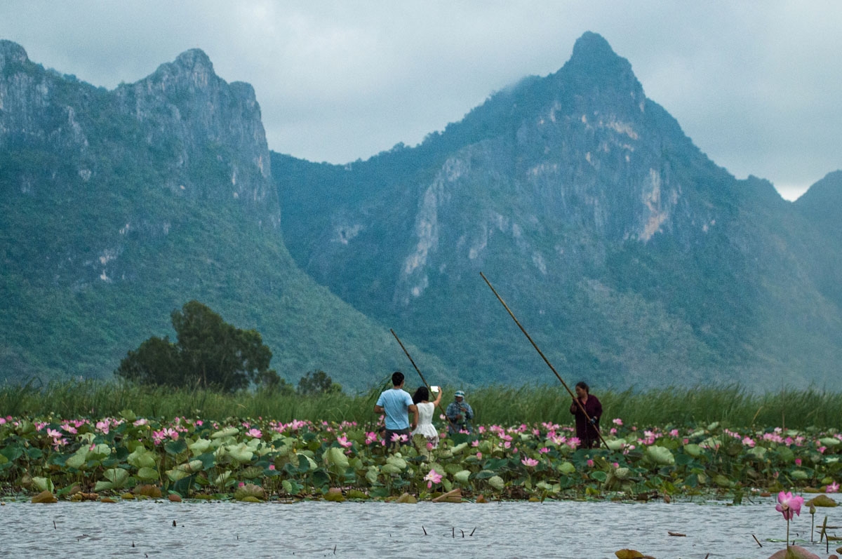 In this photograph taken on May 5, 2017, local tourist guides take tourists for canoe rides on a lake in the Khao Sam Roi Yot national park in southern Thailand.