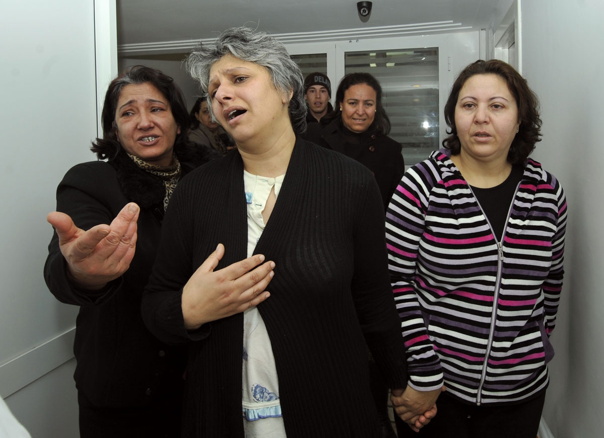 Basma Khalfaoui Belaid (C), the wife of assassinated Tunisian opposition leader and outspoken government critic Chokri Belaid, mourns over the latter's death after he was shot dead with bullets fired from close range on February 6, 2013, at a clinic in Tu