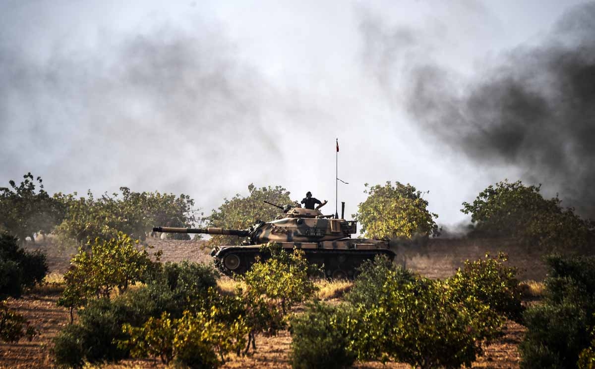 This picture taken around 5 kilometres west from the Turkish Syrian border city of Karkamis in the southern region of Gaziantep, on August 25, 2016 shows Turkish Army tanks driving to the Syrian Turkish border town of Jarabulus. This picture taken around 5 kilometres west from the Turkish Syrian border city of Karkamis in the southern region of Gaziantep, on August 25, 2016 shows Turkish Army tanks driving to the Syrian Turkish border town of Jarabulus.
