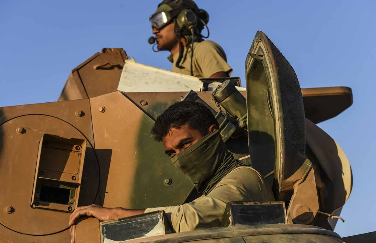 Turkish soldiers stand in a Turkish army tank driving back to Turkey from the Syrian-Turkish border town of Jarabulus on September 2, 2016 in the Turkish-Syrian border town of Karkamis. Turkish soldiers stand in a Turkish army tank driving back to Turkey from the Syrian-Turkish border town of Jarabulus on September 2, 2016 in the Turkish-Syrian border town of Karkamis.