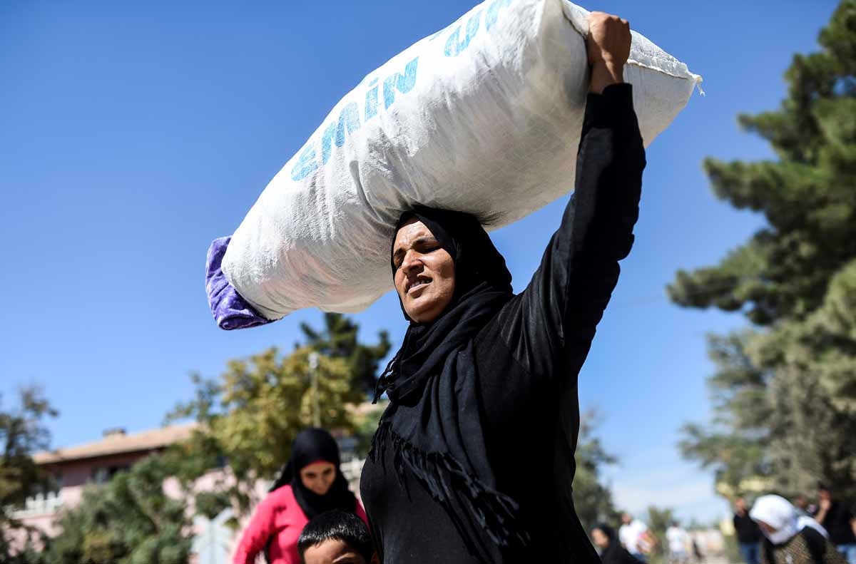Syrian refugees walk on their way back to the Syrian city of Jarabulus on September 7, 2016 at Karkamis crossing gate, in the southern region of Kilis. Syrian refugees walk on their way back to the Syrian city of Jarabulus on September 7, 2016 at Karkamis crossing gate, in the southern region of Kilis.