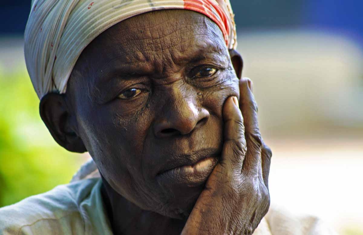 A woman follows the live transmission of the hearing of Lords Resistance Army (LRA) Rebel Commander, Dominic Ongwen, from the Lukodi disctrict of Gulu, on January 21, 2016.