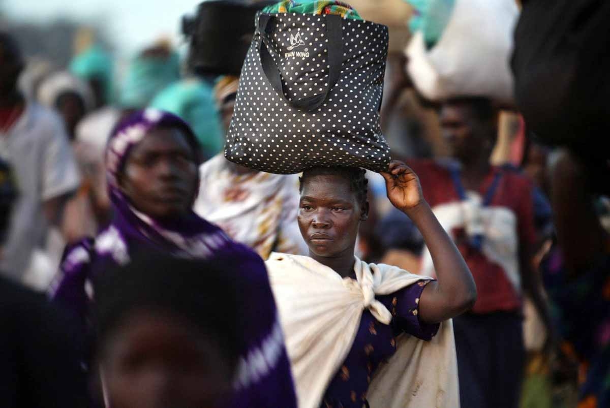 Displaced people from the villages around the northern Uganda town of Lira return home 22 November 2003 after having spent the night in safety downtown Lira. Displaced people from the villages around the northern Uganda town of Lira return home 22 November 2003 after having spent the night in safety downtown Lira.