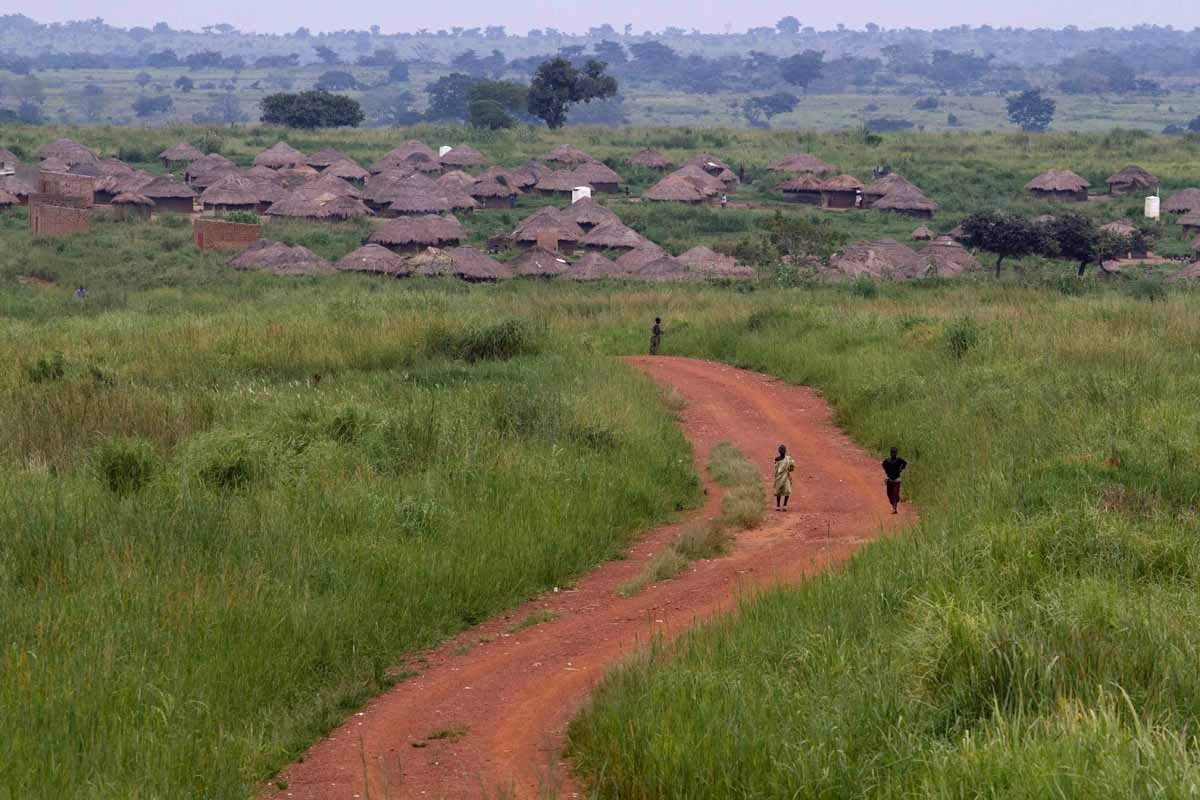 Children walk on a road leading to the northern Ugandan village of Amuru on August 26, 2010.