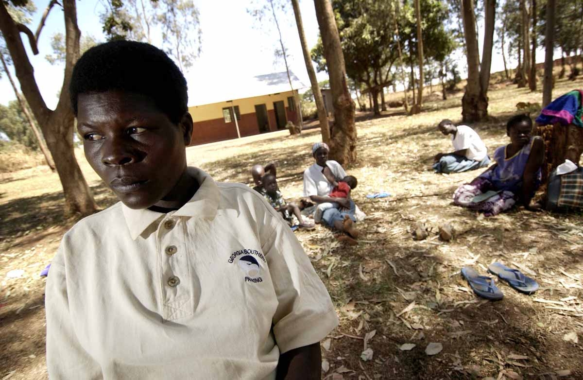 Margret, 33, former wife of Lord Resistance Army (LRA) leader Joseph Kony stands beside a bicycle 08 February 2006 at the Santa Monica Tayloring Centre for girls in Gulu, northern Uganda