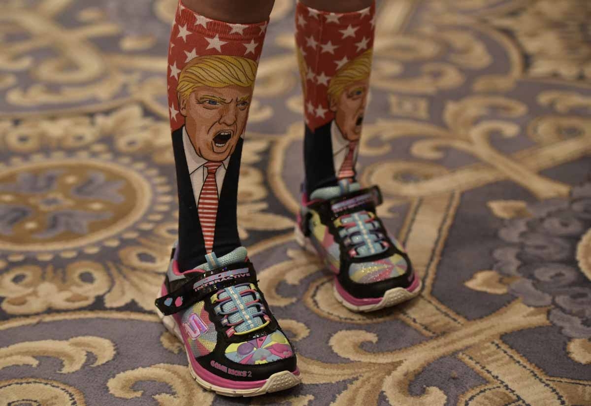 A young supporter wears socks with the image of Republican presidential nominee Donald Trump ahead of his press conference at the Trump International Hotel, in Washington, DC on September 16, 2016. A young supporter wears socks with the image of Republican presidential nominee Donald Trump ahead of his press conference at the Trump International Hotel, in Washington, DC on September 16, 2016.