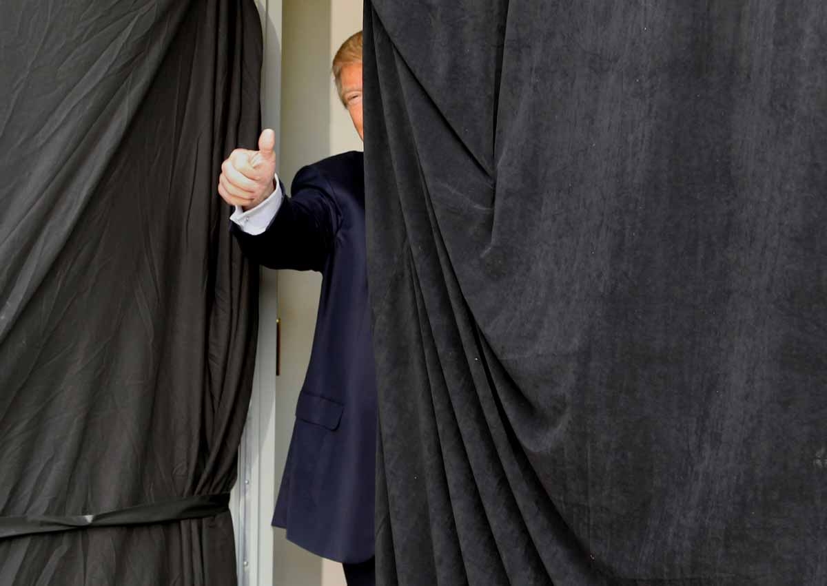 Republican presidential candidate Donald Trump gives a thumbs up from behind the curtain before taking the stage at an event on October 15, 2016 in Portsmouth, New Hampshire. Republican presidential candidate Donald Trump gives a thumbs up from behind the curtain before taking the stage at an event on October 15, 2016 in Portsmouth, New Hampshire.