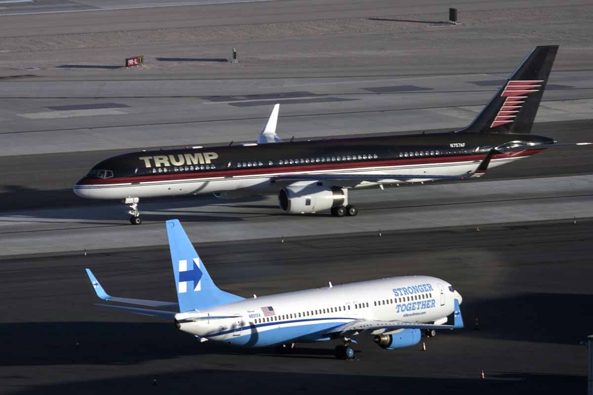 Republican presidential nominee Donald Trump's plane (TOP) passes Democratic presidential nominee Hillary Clinton's campaign plane at McCarran International Airport on October 18, 2016 in Las Vegas, Nevada, on the eve of the two candidates' third and fina Republican presidential nominee Donald Trump's plane (TOP) passes Democratic presidential nominee Hillary Clinton's campaign plane at McCarran International Airport on October 18, 2016 in Las Vegas, Nevada, on the eve of the two candidates' third and fina