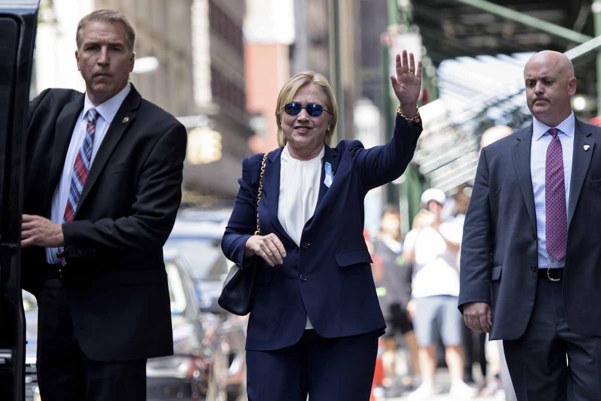 US Democratic presidential nominee Hillary Clinton waves to the press as she leaves her daughter's apartment building after resting on September 11, 2016 in New York.