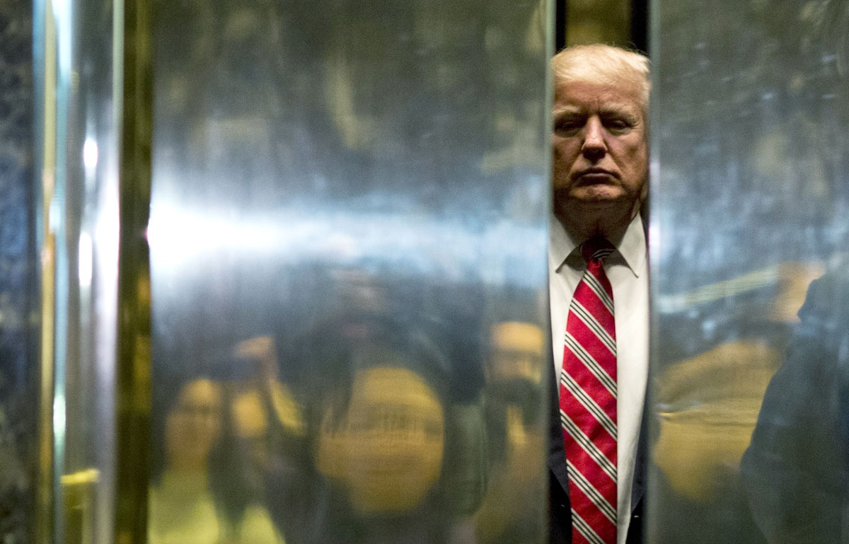 US President-elect Donald Trump boards the elevator after escorting Martin Luther King III to the lobby after meetings at Trump Tower in New York City on January 16, 2017.
