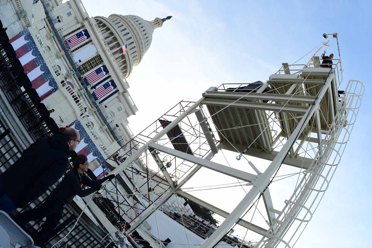 Mandel Ngan (2nd L) pulls equipment up the center stand camera position ahead ofs an inaugural dress rehearsal on the North media riser on the West side of the US Capitol on January 15, 2017 in Washington, DC five days ahead of the inauguration of US Pres
