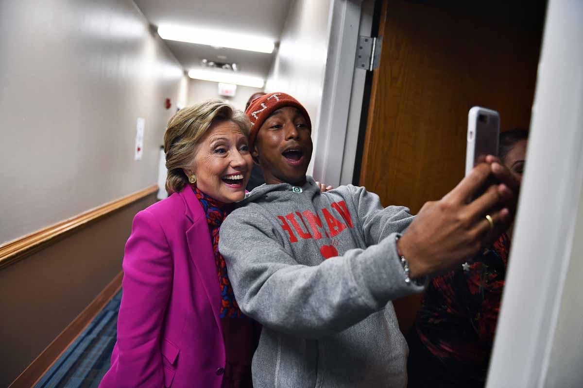 US Democratic presidential nominee Hillary Clinton poses with singer Pharrell Williams for a selfie backstage before a campaign rally in Raleigh, North Carolina, on November 3, 2016. US Democratic presidential nominee Hillary Clinton poses with singer Pharrell Williams for a selfie backstage before a campaign rally in Raleigh, North Carolina, on November 3, 2016.
