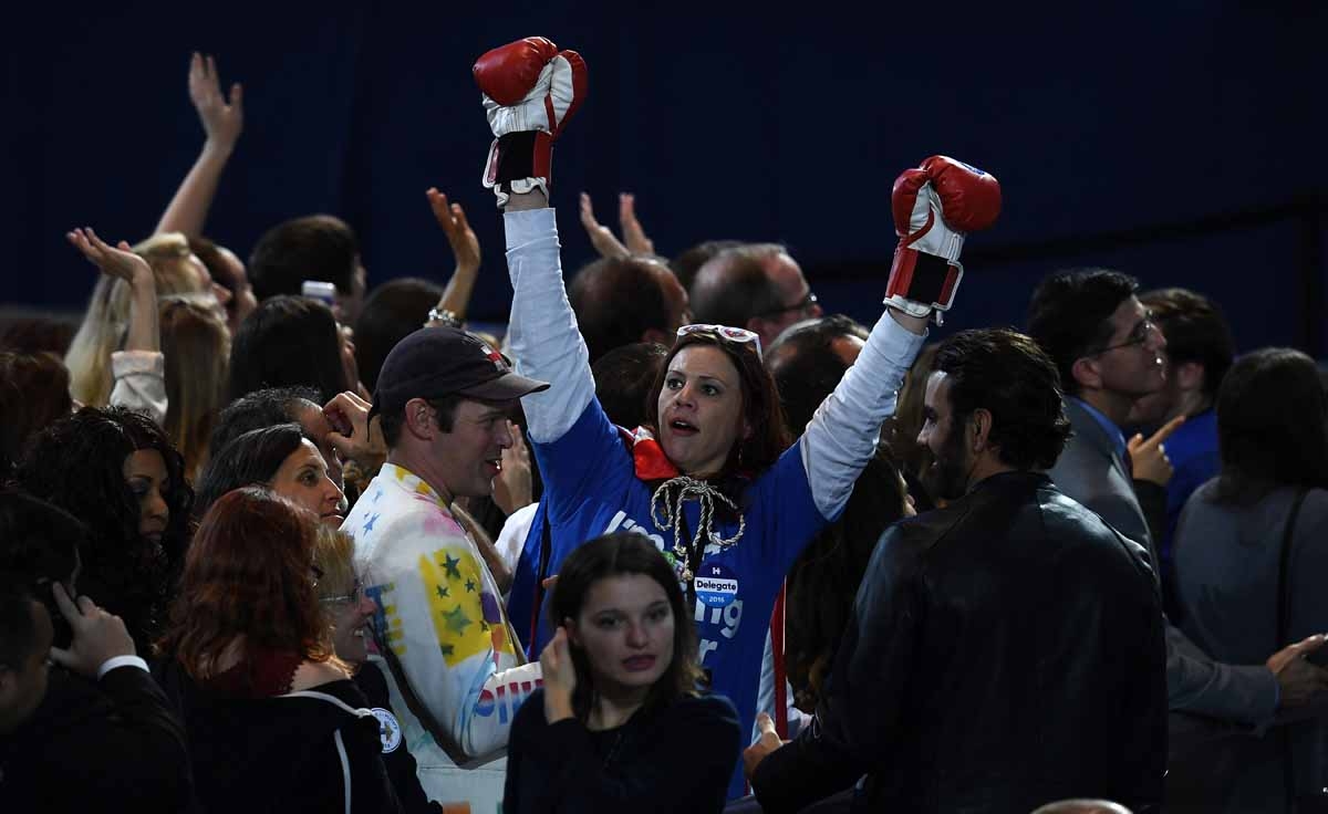 A supporter of Democratic presidential nominee Hillary Clinton raises her arms with boxing gloves on during election night at the Jacob K. Javits Convention Center in New York on November 8, 2016. A supporter of Democratic presidential nominee Hillary Clinton raises her arms with boxing gloves on during election night at the Jacob K. Javits Convention Center in New York on November 8, 2016.