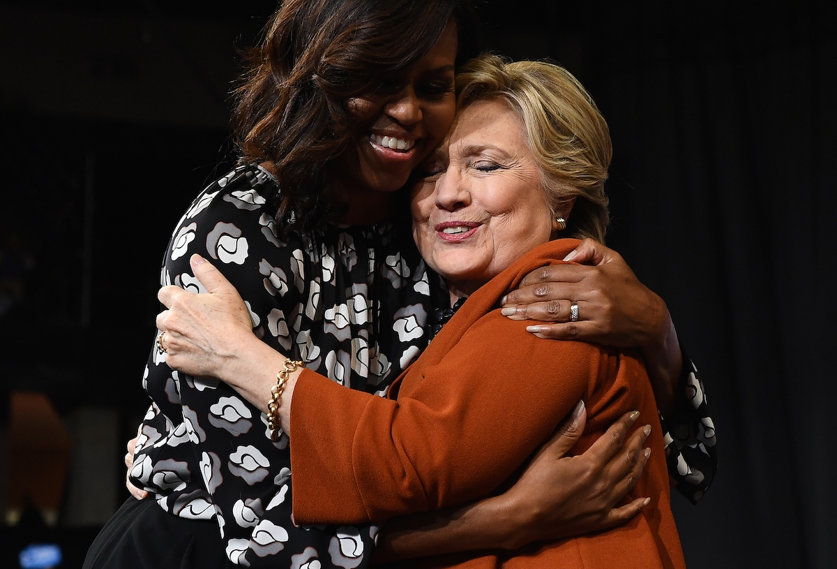 US First Lady Michelle Obama embraces Democratic presidential nominee Hillary Clinton during a campaign rally in Winston-Salem, North Carolina on October 27, 2016. US First Lady Michelle Obama embraces Democratic presidential nominee Hillary Clinton during a campaign rally in Winston-Salem, North Carolina on October 27, 2016.