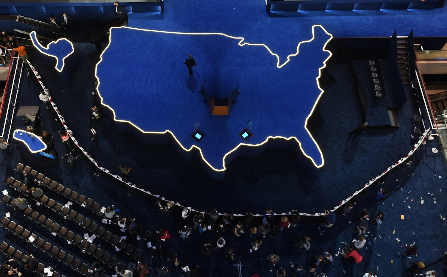 A man walks off an empty stage after Democratic presidential nominee Hillary Clinton did not arrive to speak during election night at the Jacob K. Javits Convention Center in New York on November 9, 2016. A man walks off an empty stage after Democratic presidential nominee Hillary Clinton did not arrive to speak during election night at the Jacob K. Javits Convention Center in New York on November 9, 2016.