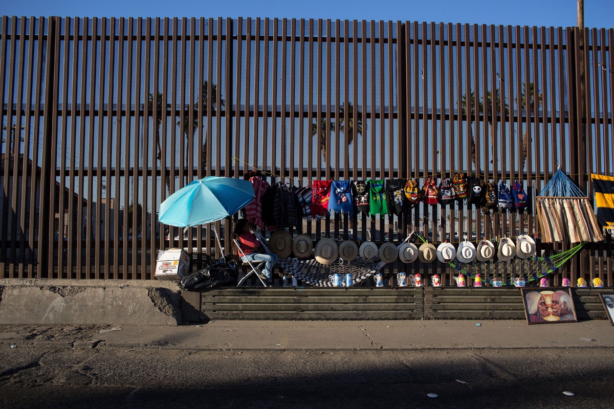 Street vendors use the border fence as a shelf to display their items on the US/Mexico border in Mexicali on February 14, 2017, northwestern Mexico.