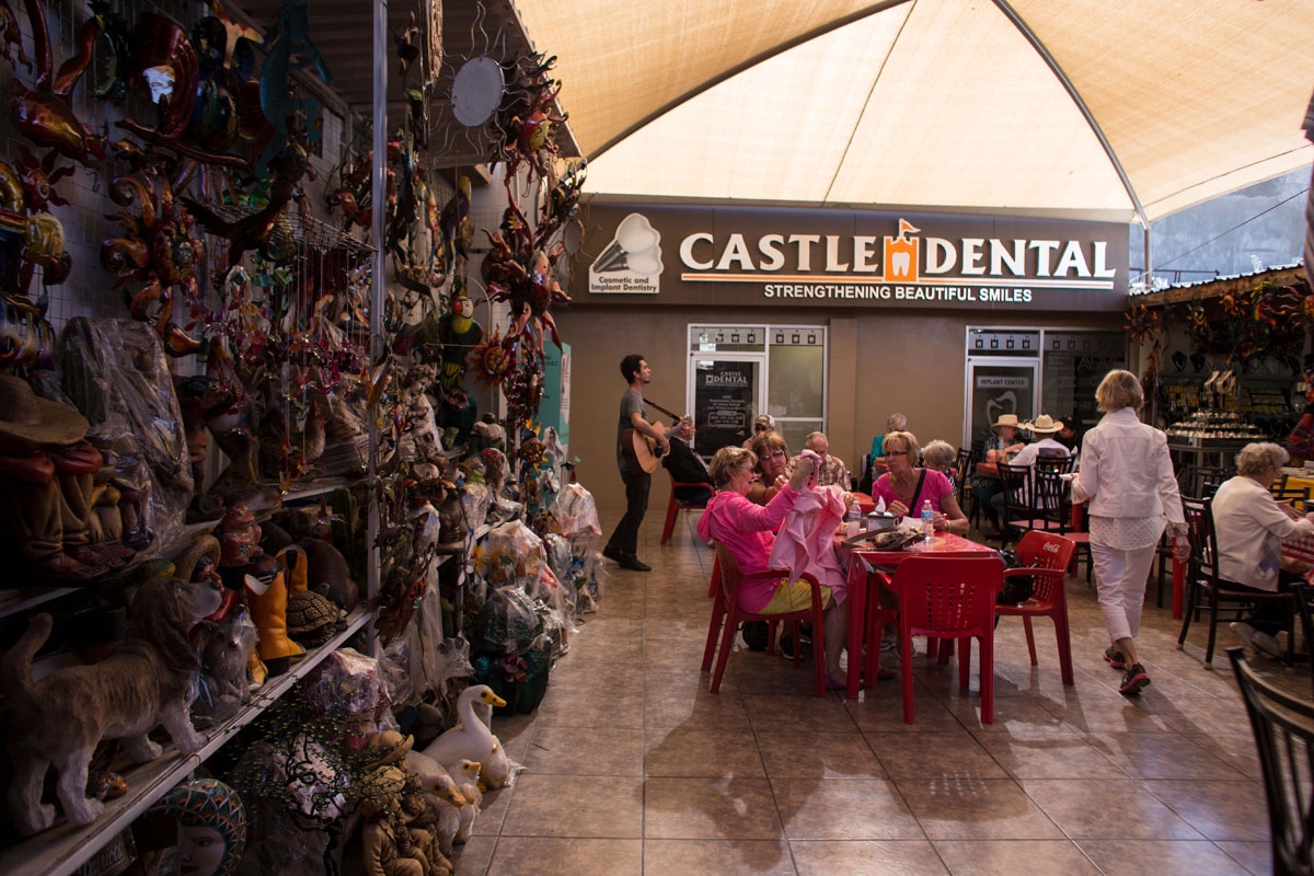 Visitors from the United States sit near a souvenir stand and dental clinic in downtown Los Algodones, near the US/Mexico border on February 15, 2017, northwestern Mexico.