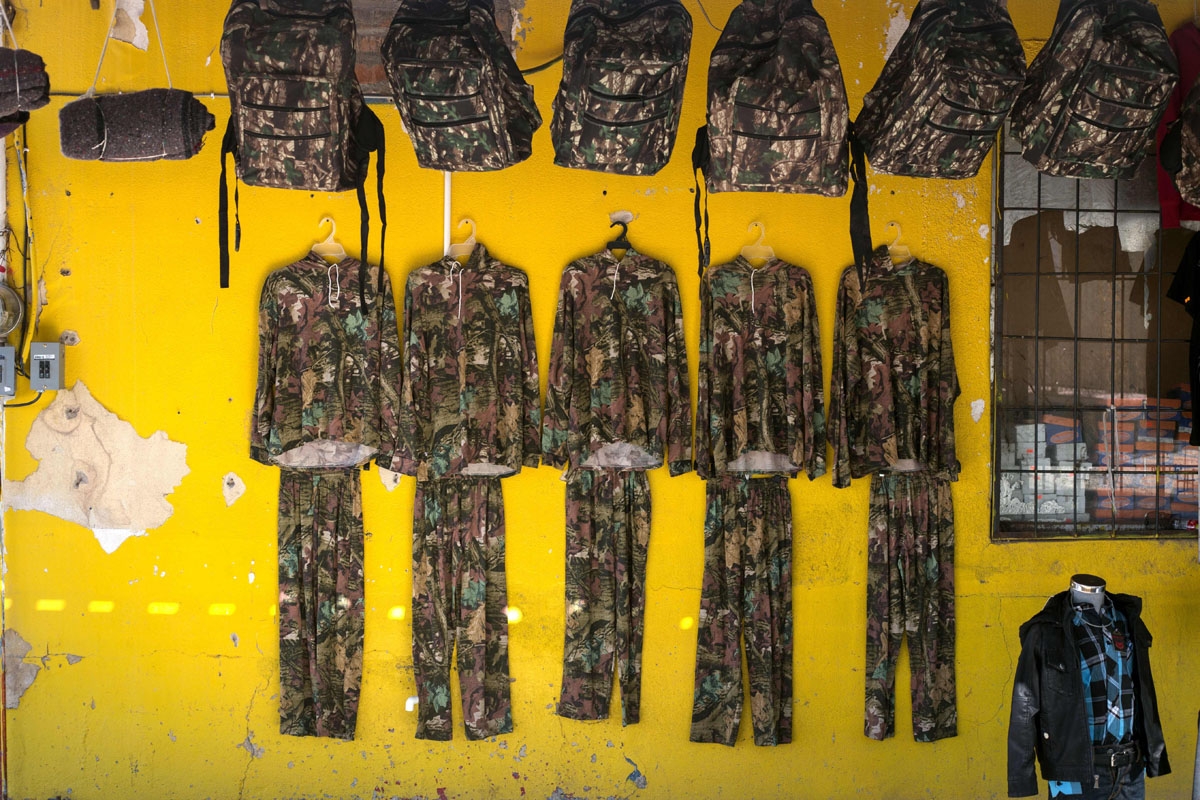 Backpacks and clothing with camouflage are displayed for sale among other goods for migrants crossing the desert, at a local shop in Altar some 117 kilometres south the US/Mexico border, on February 16, 2017, northwestern Mexico.