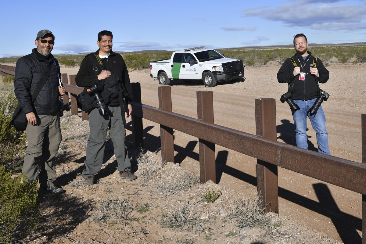 (L-R) AFP's photographers Guillermo Arias, Yuri Cortez and Jim Watson are pictured at metal fence between US and Mexico in Puerto Palomas, Chihuahua state on February 19, 2017.