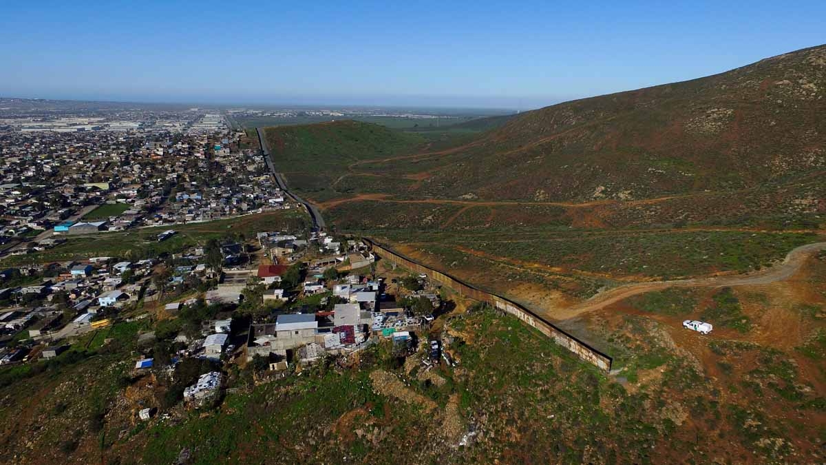 Aerial picture taken with a drone of the urban fencing on the border between the US and Mexico at El Nido del Aguila, outskirts of Tijuana, northwestern Mexico on January 26, 2017.