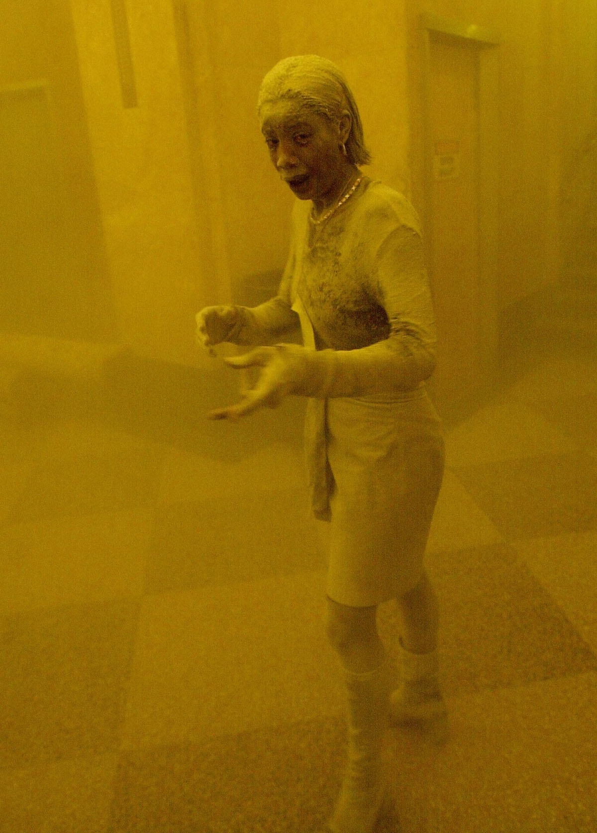 This 11 September 2001 file photo shows Marcy Borders covered in dust as she takes refuge in an office building after one of the World Trade Center towers collapsed in New York