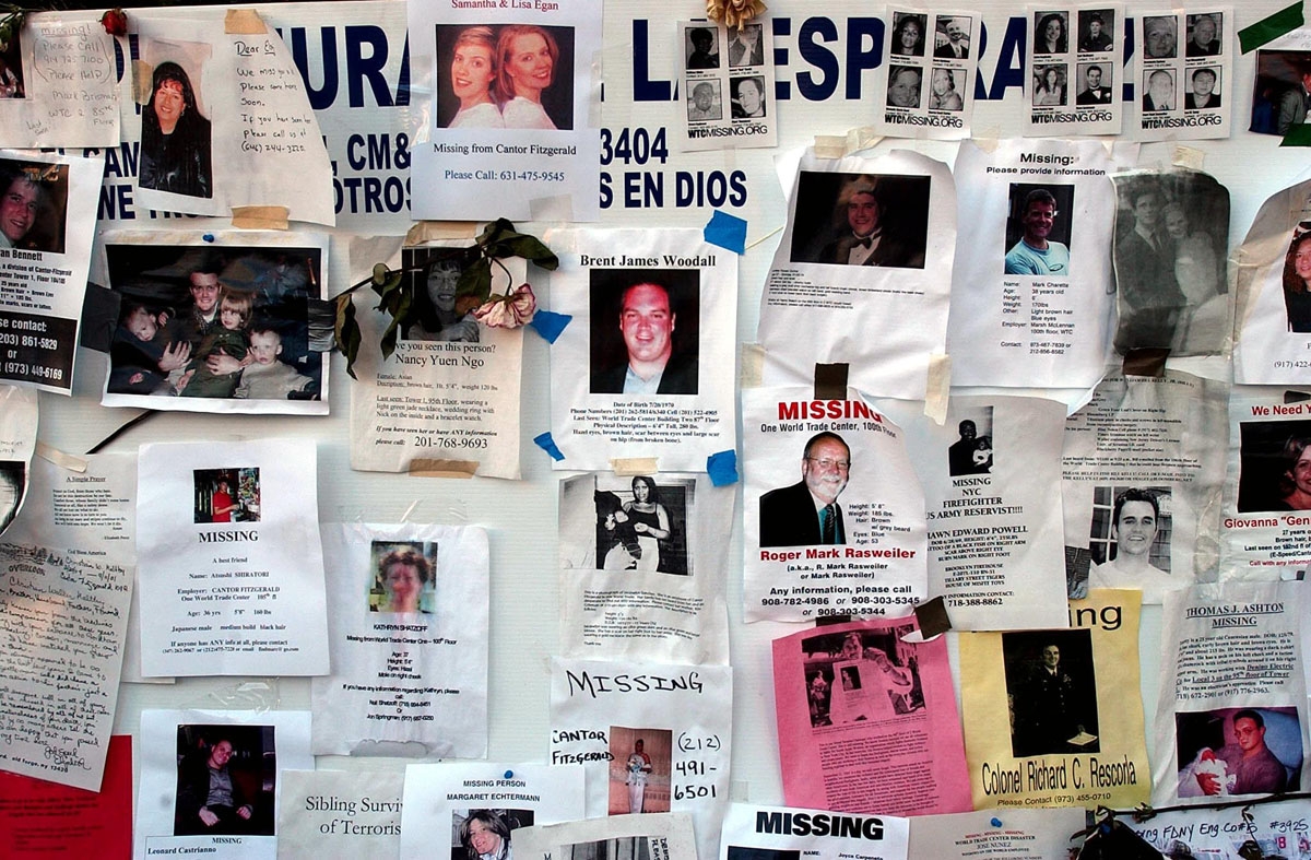 Posters for victims of the World Trade Center are displayed near a memorial for victims of the World Trade Center attack 19 September 2001