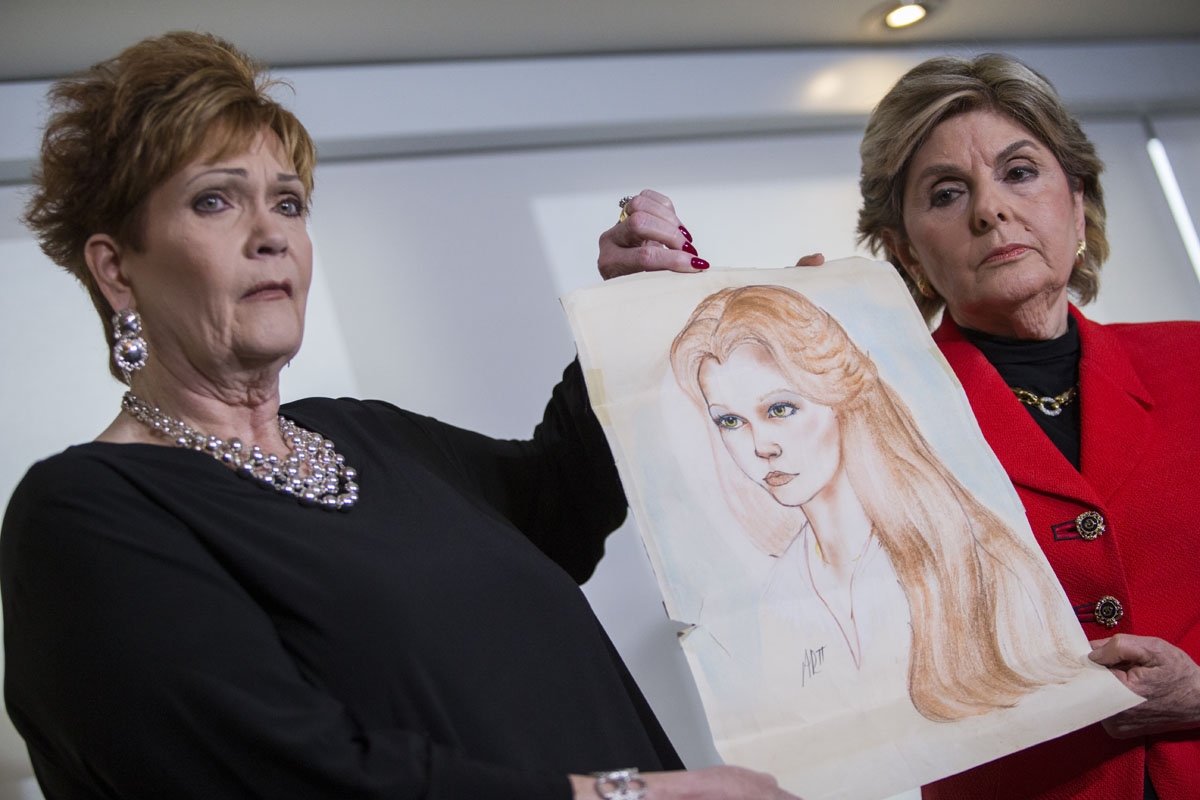 Attorney Gloria Allred (R) and Beverly Young Nelson hold up a drawing of Nelson when she was younger during a press conference on November 13, 2017, in New York, alledging that Roy Moore sexually assaulted Nelson when she was a minor in Alabama without he