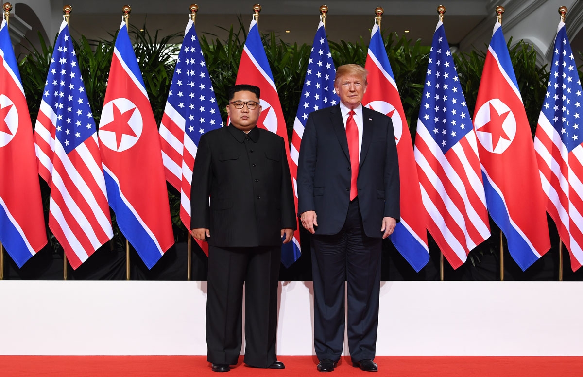 US President Donald Trump (R) poses with North Korea's leader Kim Jong Un (L) at the start of their historic US-North Korea summit, at the Capella Hotel on Sentosa island in Singapore on June 12, 2018.