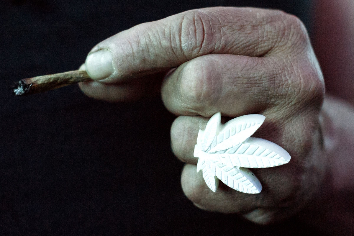 A member of the International Church of Cannabis holds a joint during the church's 4/20 celebration on April 20, 2018 in Denver, Colorado.