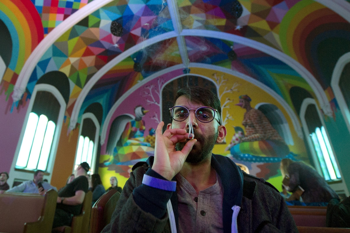 Tushar Mallick of England, a member of the International Church of Cannabis smokes a joint during a 4/20 celebration on April 20, 2018 in Denver, Colorado.