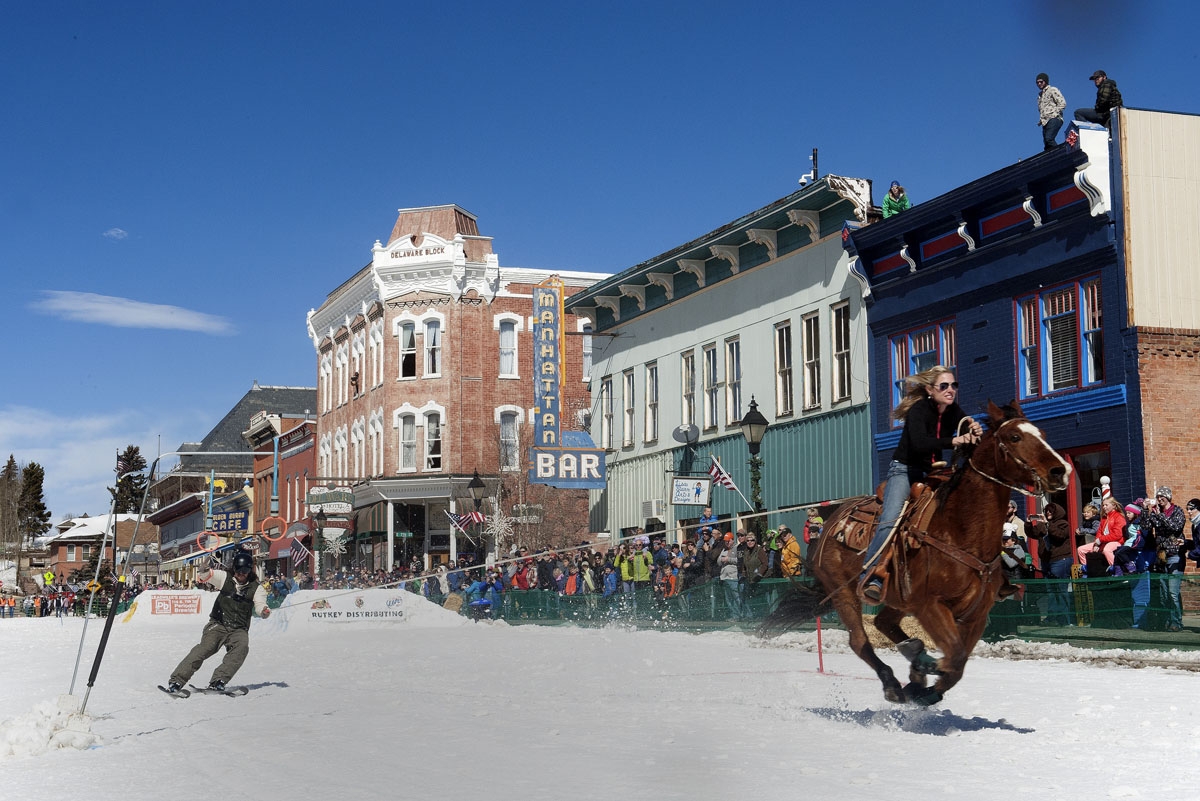 A rider races down Harrison Avenue while a skier navigates the course during the 68th annual Leadville Ski Joring weekend competition on Saturday, March 4, 2017 in Leadville, Colorado.