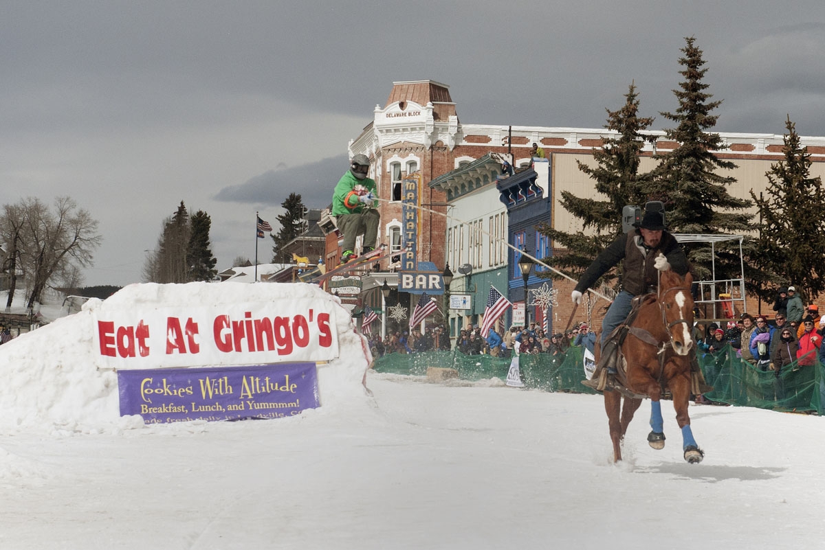 Rider Will James races down Harrison Avenue as skier Sean Gerber airs out off the first jump of the Leadville skijoring course during the 68th annual Leadville Ski Joring weekend competition on March 5, 2017 in Leadville, Colorado.
