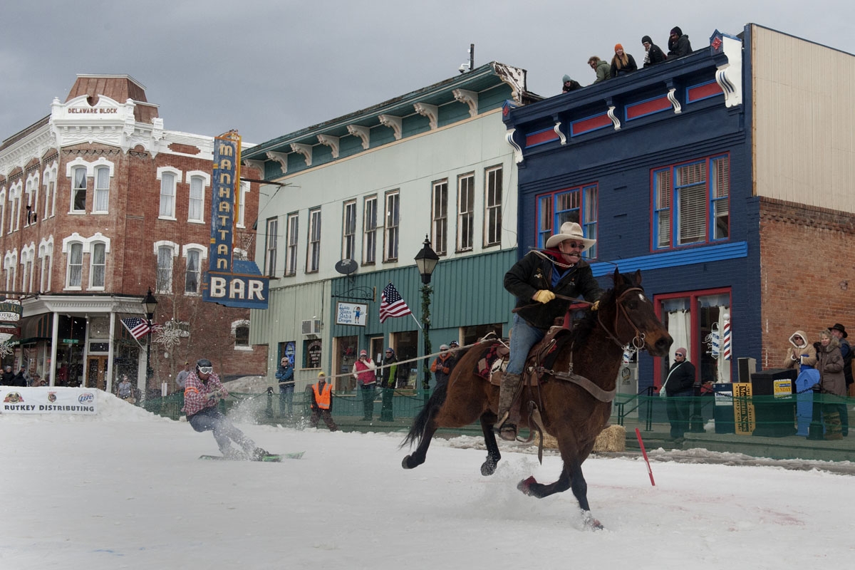 Rider Jeff Dahl races down Harrison Avenue towing skier and son Jason Dahl during the 68th annual Leadville Ski Joring weekend competition on March 5, 2017 in Leadville, Colorado.