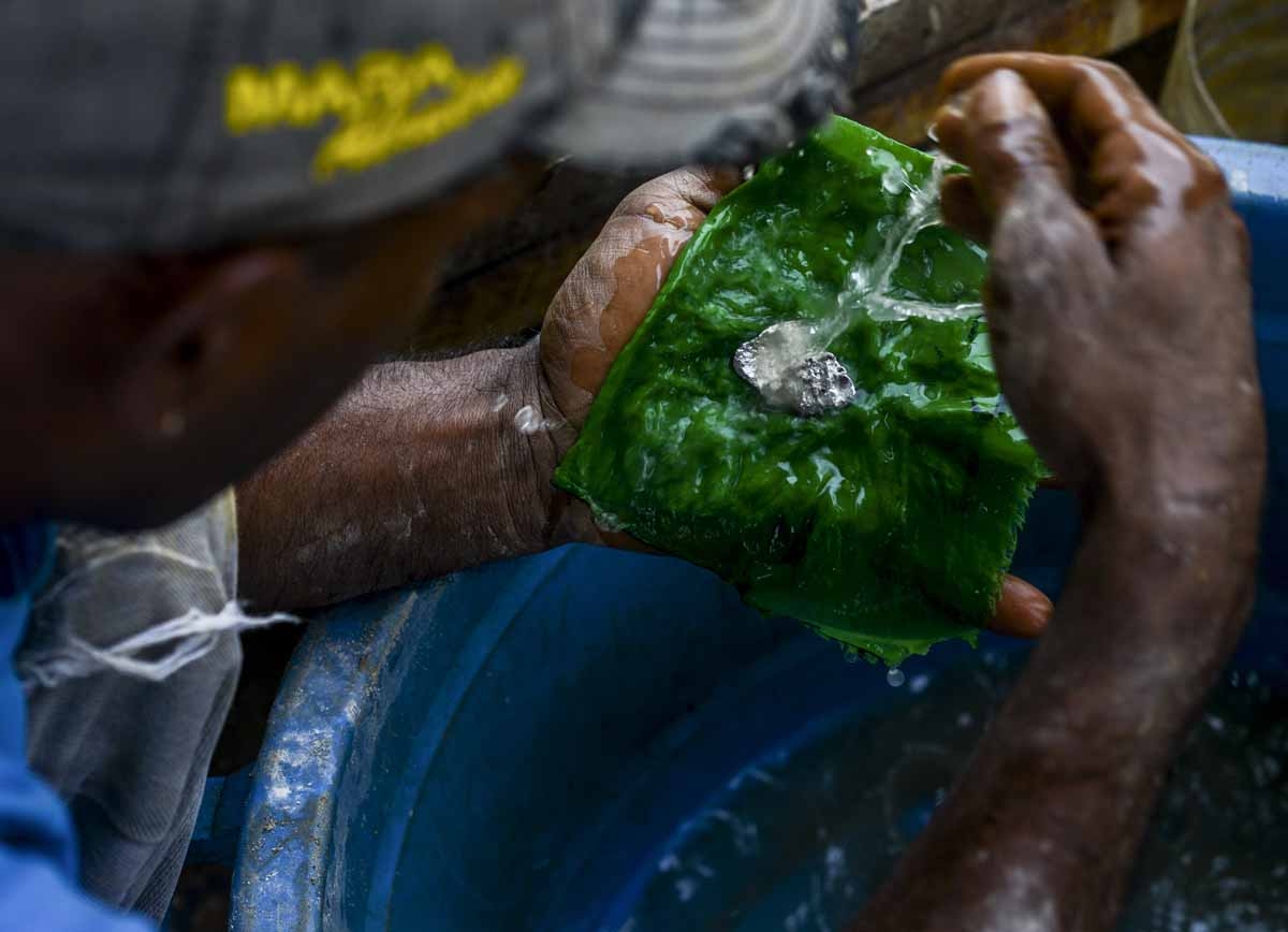 A man holds a gold-mercury amalgam at a gold mine in El Callao, Bolivar state, southeastern Venezuela on February 25, 2017.
