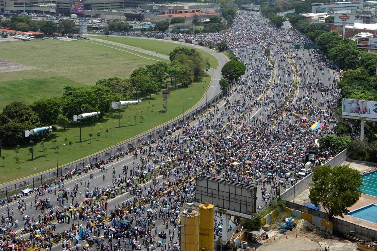 Thousands of Venezuelan opposition activists demonstrate against President Nicolas Maduro in Caracas, on April 24, 2017. Protesters rallied on Monday vowing to block Venezuela's main roads to raise pressure on Maduro after three weeks of deadly unrest tha