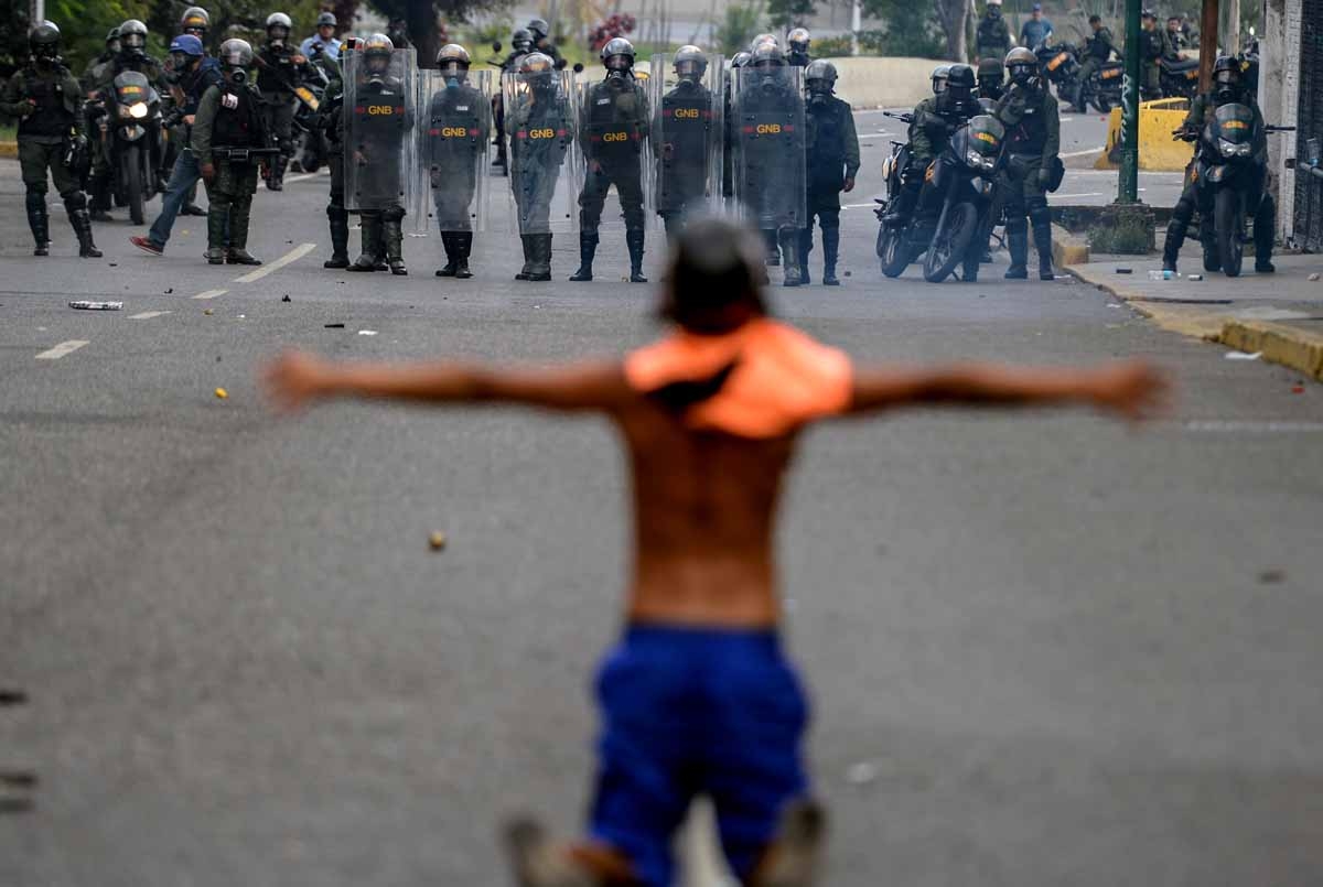 Opposition activists clash with riot police during a protest against President Nicolas Maduro in Caracas on April 26, 2017.